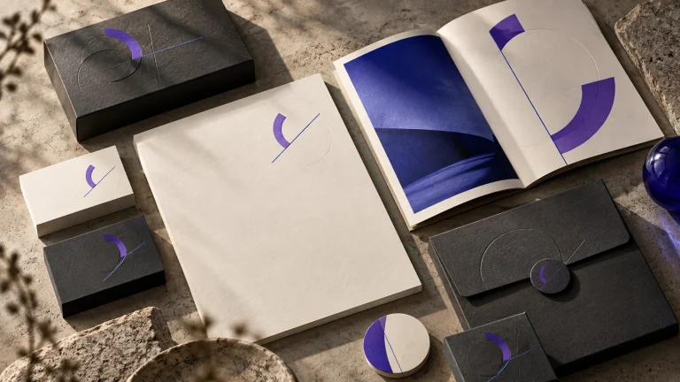 Placeholder identity study with cream stationery, charcoal packaging and violet geometric marks